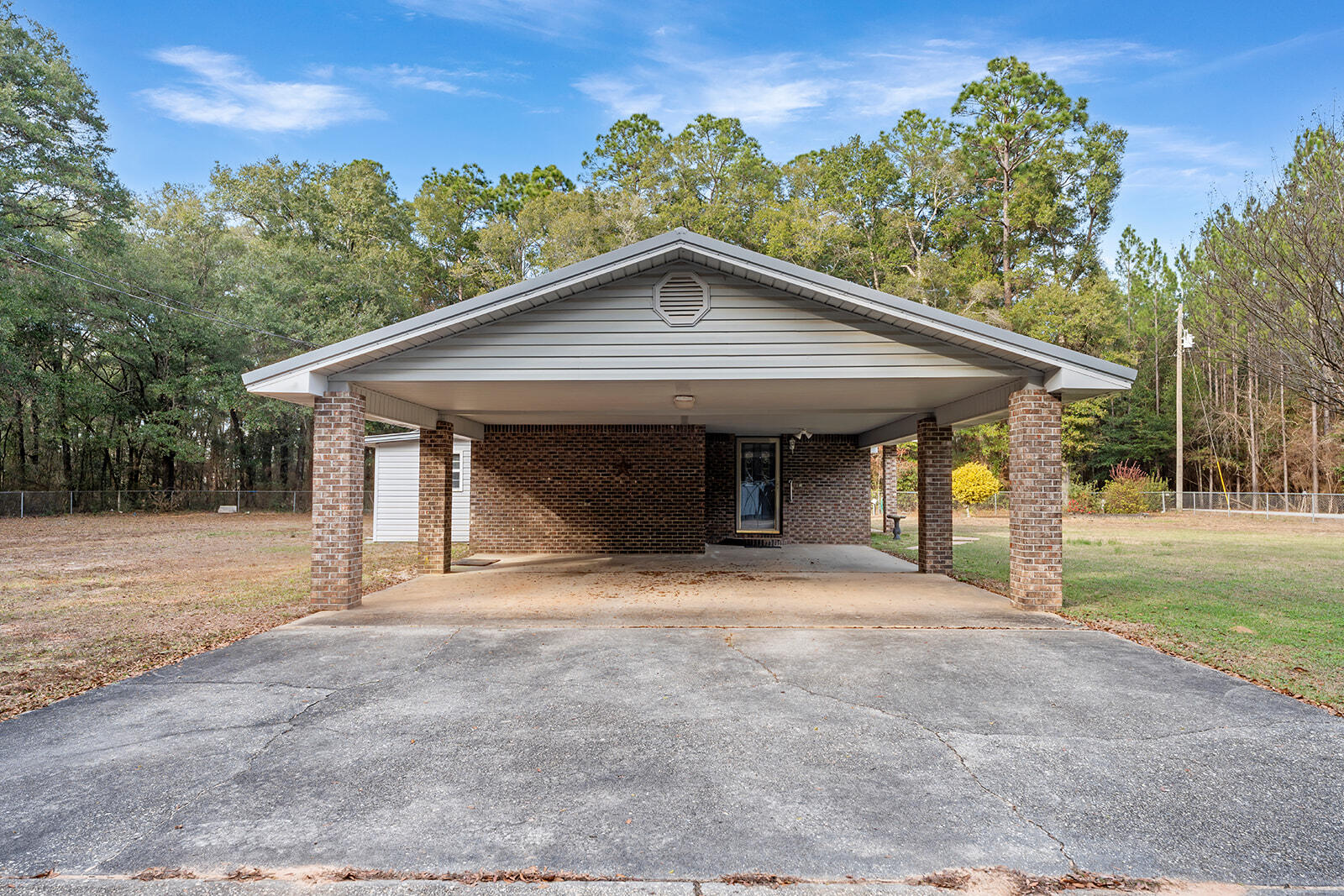 4780 Griffith Road Holt, FL 32564 - Photo 20 of 44 a front view of a house with a yard and garage