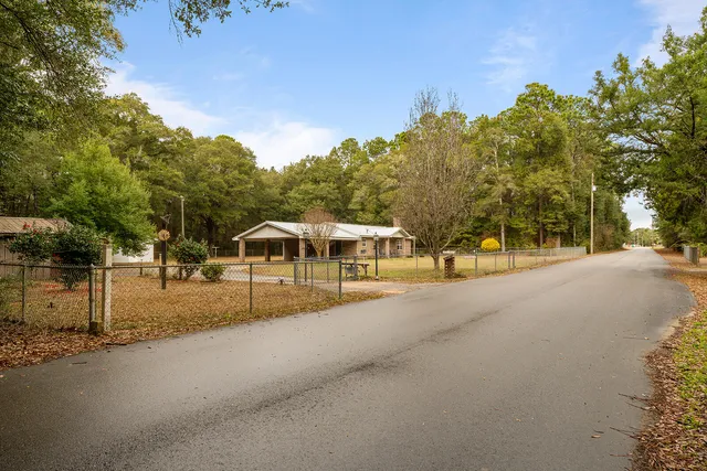 an aerial view of a house with a yard and lake view
