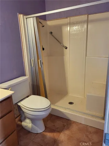 a bathroom with a shower and a toilet