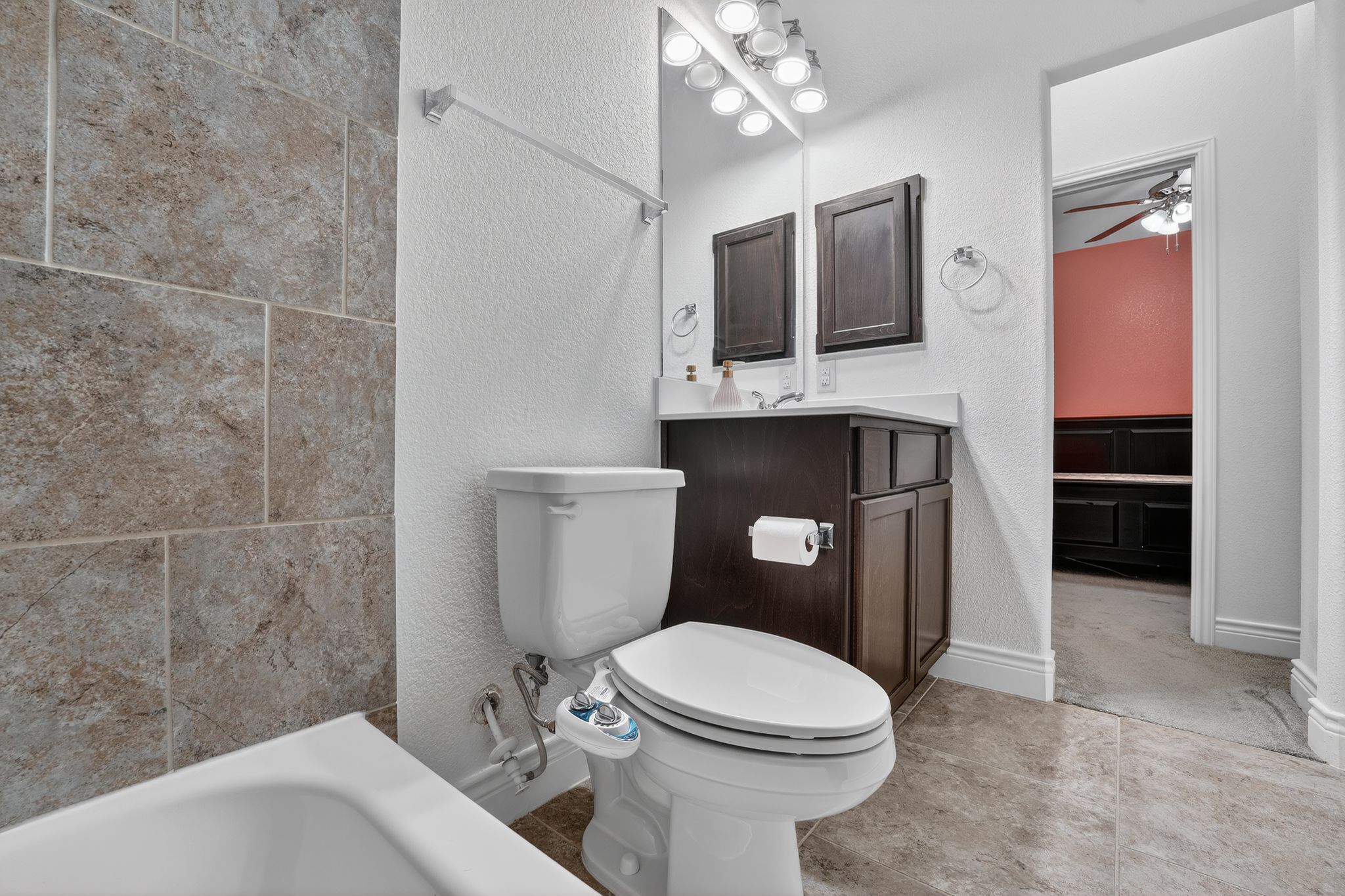 400 Cortona Lane Georgetown, TX 78628 - Photo 30 of 40 Full bathroom with a textured wall, vanity, a bathtub, and ceiling fan