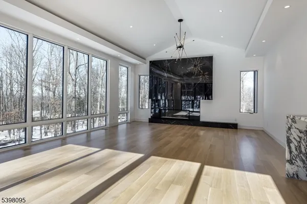wooden floor in an empty room with a fireplace and wooden floor