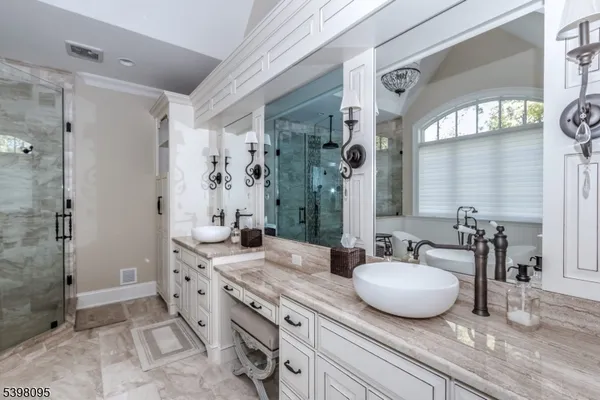 a spacious bathroom with a granite countertop sink and a mirror