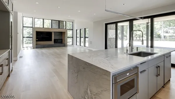 an open kitchen with a sink and a fireplace