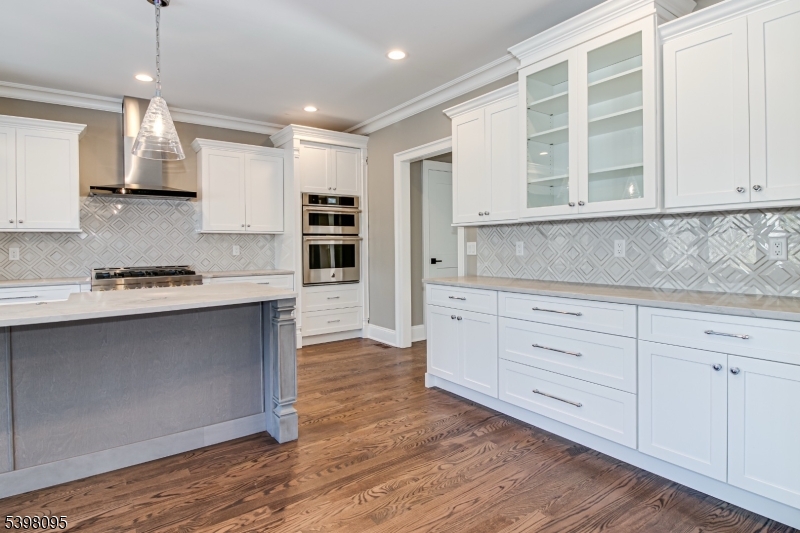1 Juniper Pointe Trail Dunellen, NJ 08812 - Photo 35 of 44 a kitchen with stainless steel appliances granite countertop a stove a sink and white cabinets with wooden floor