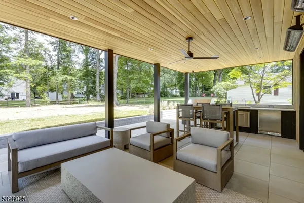 a living room with furniture and floor to ceiling windows