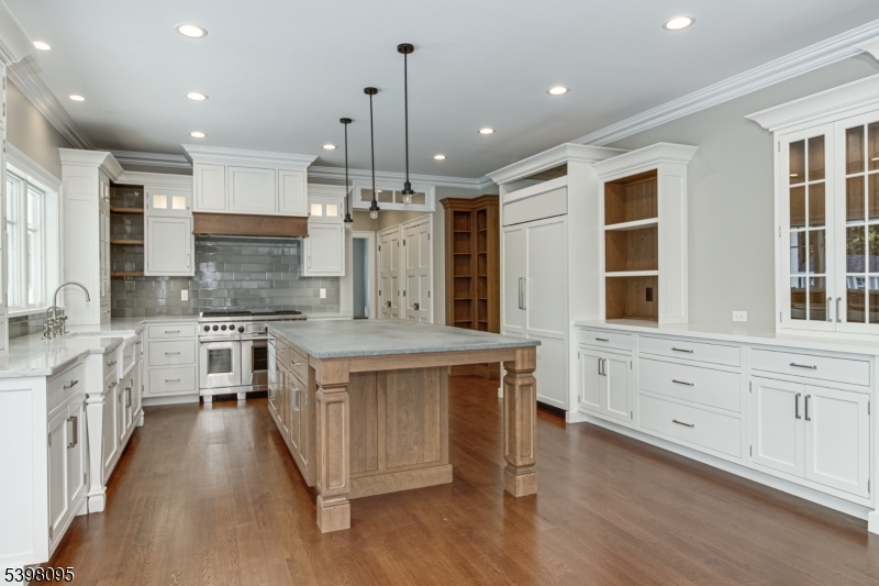 1 Juniper Pointe Trail Dunellen, NJ 08812 - Photo 6 of 44 a large kitchen with stainless steel appliances kitchen island granite countertop a large stove a sink dishwasher and white cabinets with wooden floor
