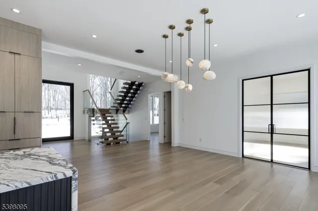 a large kitchen with stainless steel appliances granite countertop a large counter top a stove and a wooden floors