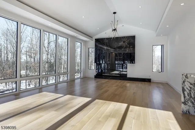 a view of a dining room with furniture and chandelier