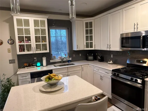 a kitchen with a sink a stove and microwave