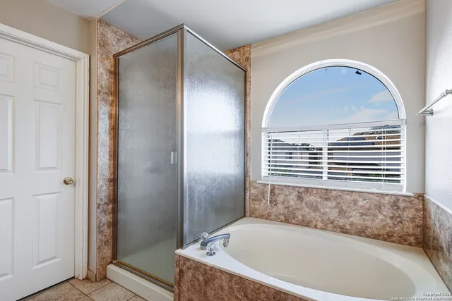 a bathroom with a bathtub and shower