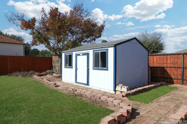 a backyard of a house with wooden fence
