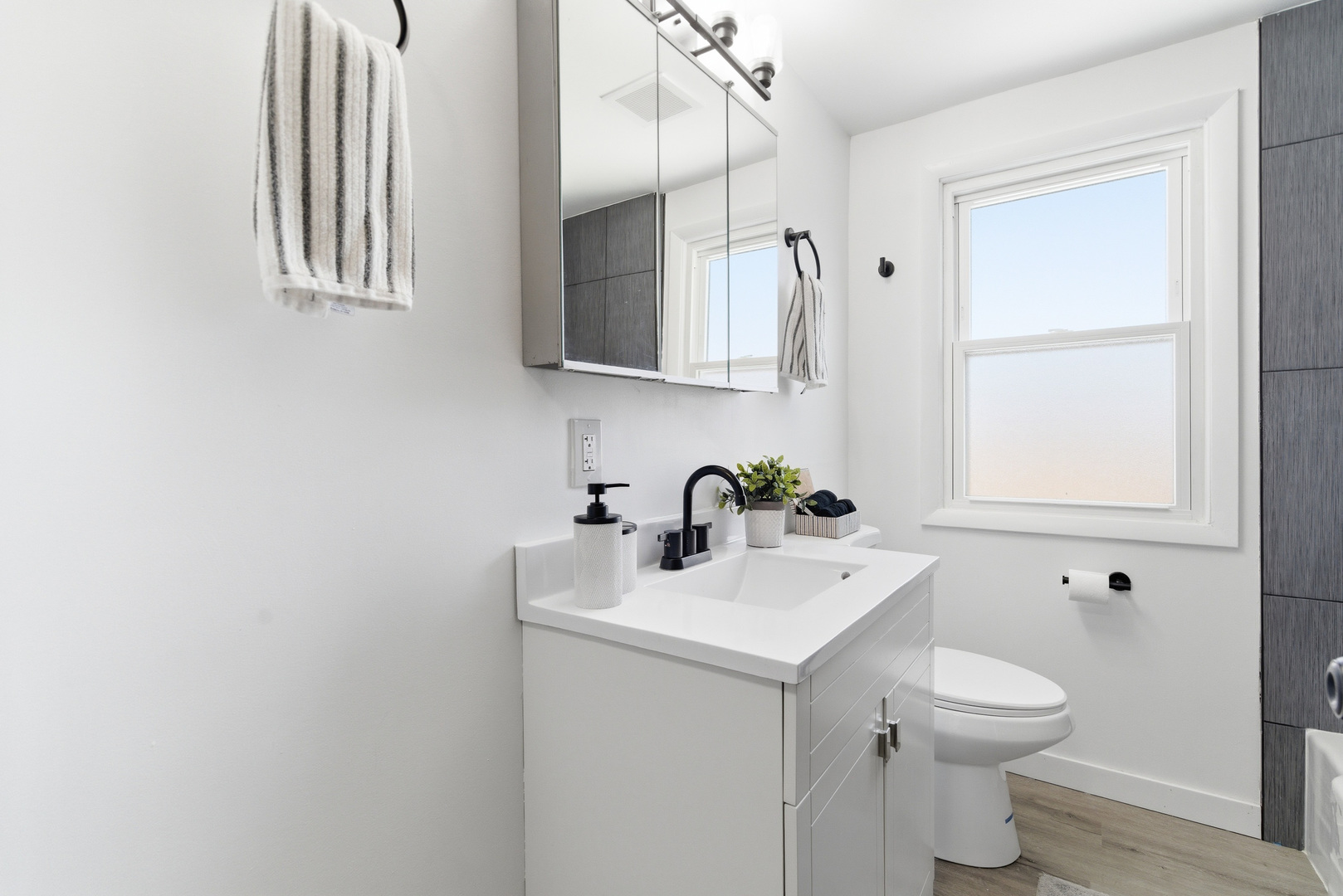 7545 Beloit Avenue Bridgeview, IL 60455 - Photo 14 of 31 a bathroom with a sink a toilet and mirror