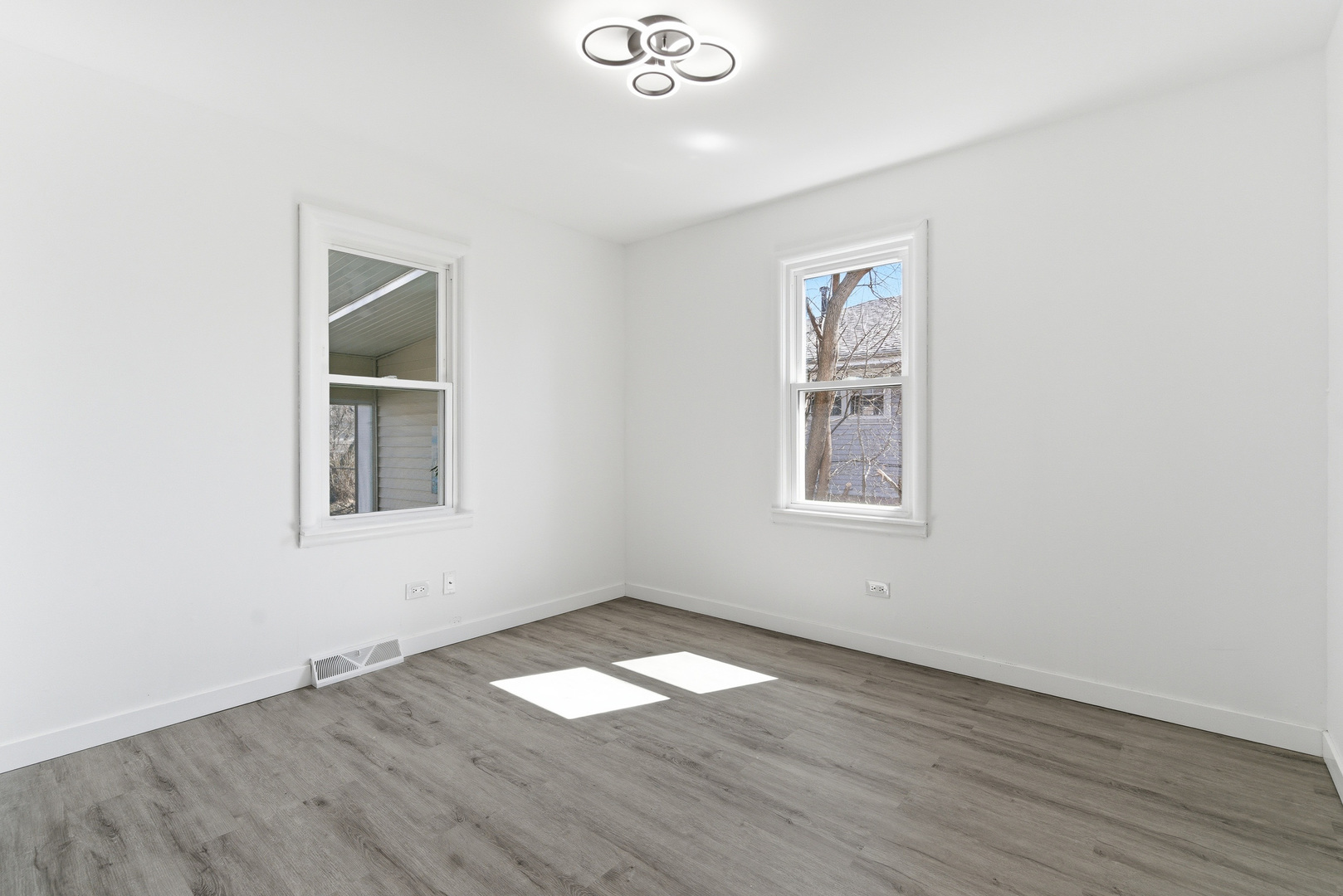 7545 Beloit Avenue Bridgeview, IL 60455 - Photo 16 of 31 an empty room with wooden floor and windows