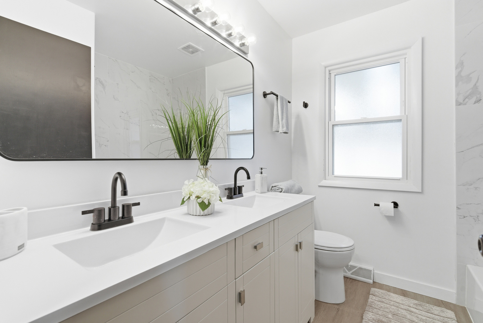 7545 Beloit Avenue Bridgeview, IL 60455 - Photo 17 of 31 a bathroom with a sink a toilet and a mirror