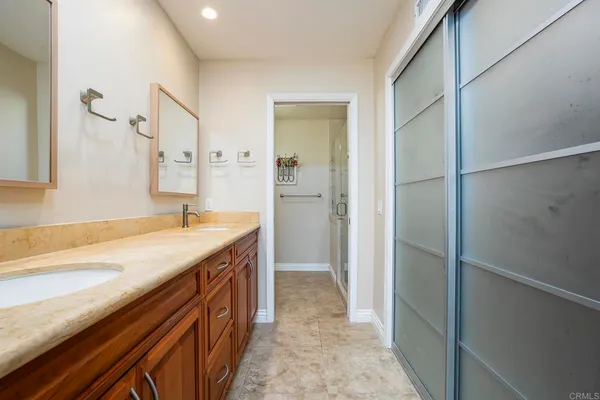 a spacious bathroom with a granite countertop sink and a mirror