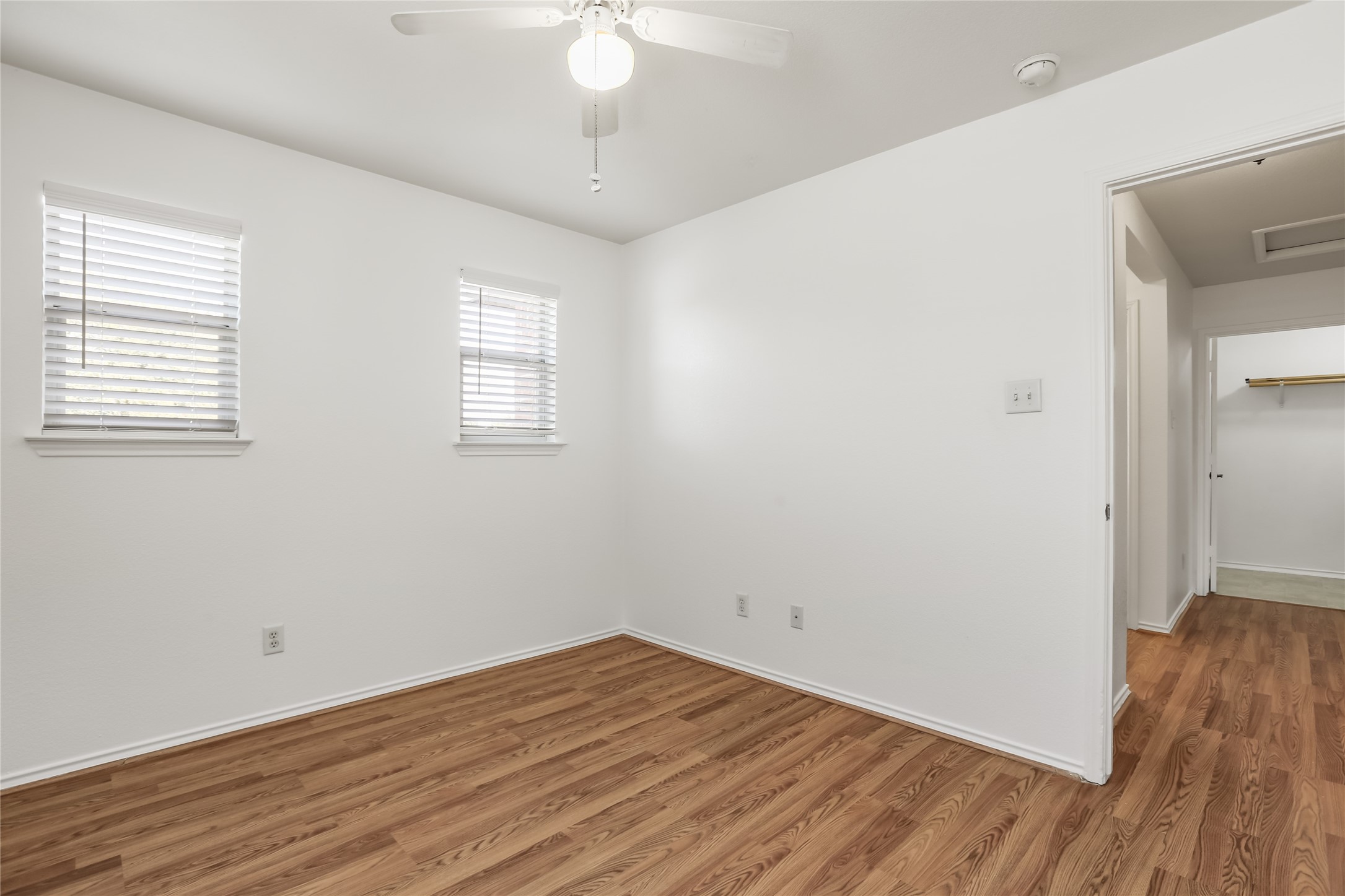 2010 Ashberry Trail Georgetown, TX 78626 - Photo 16 of 24 Unfurnished room with wood finished floors and a ceiling fan