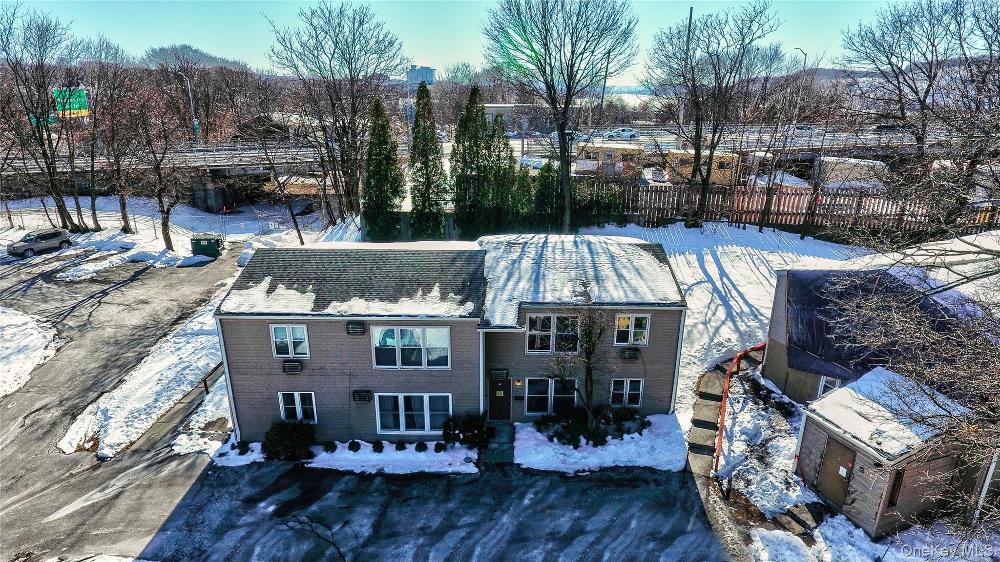 19 Gerald Drive, Unit B2 Poughkeepsie, NY 12601 - Photo 13 of 14 a view of a patio with table and chairs with wooden floor and fence