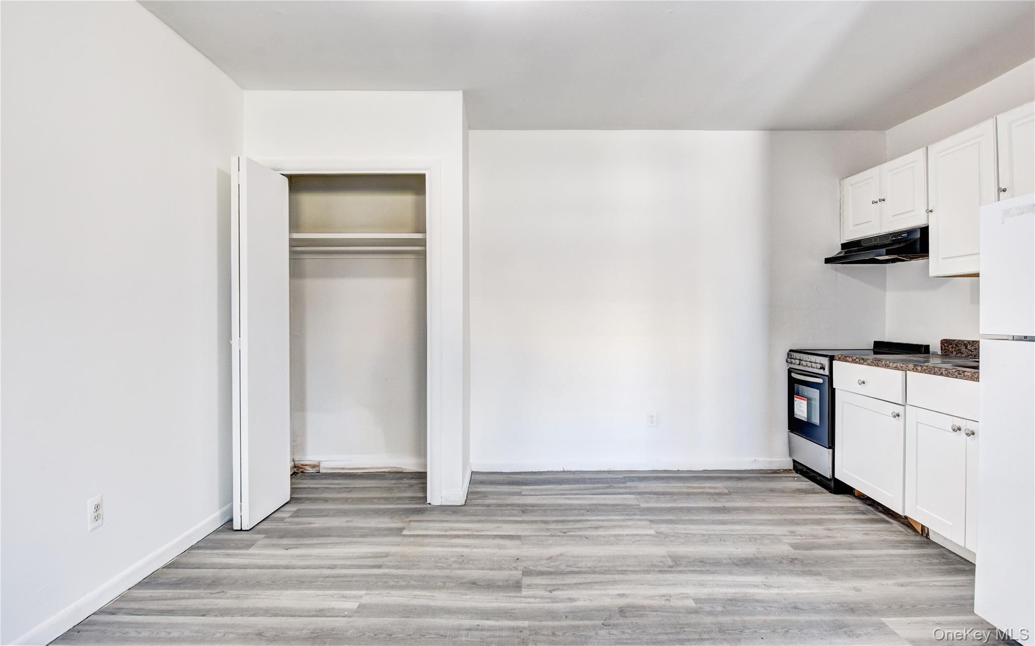 19 Gerald Drive, Unit B2 Poughkeepsie, NY 12601 - Photo 3 of 14 a view of a kitchen with a sink and dishwasher a refrigerator with white cabinets