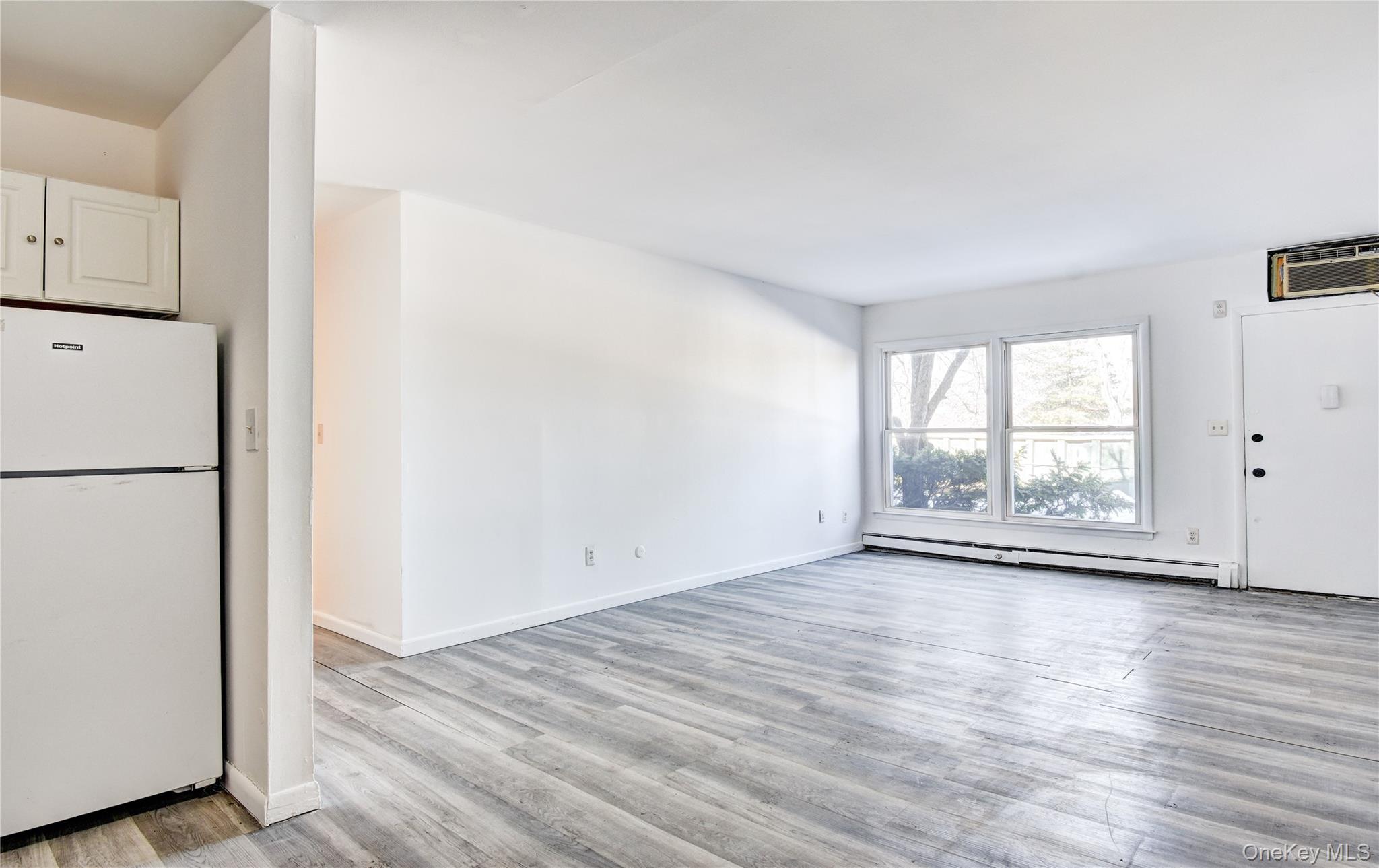 19 Gerald Drive, Unit B2 Poughkeepsie, NY 12601 - Photo 6 of 14 a view of an empty room with wooden floor and a window