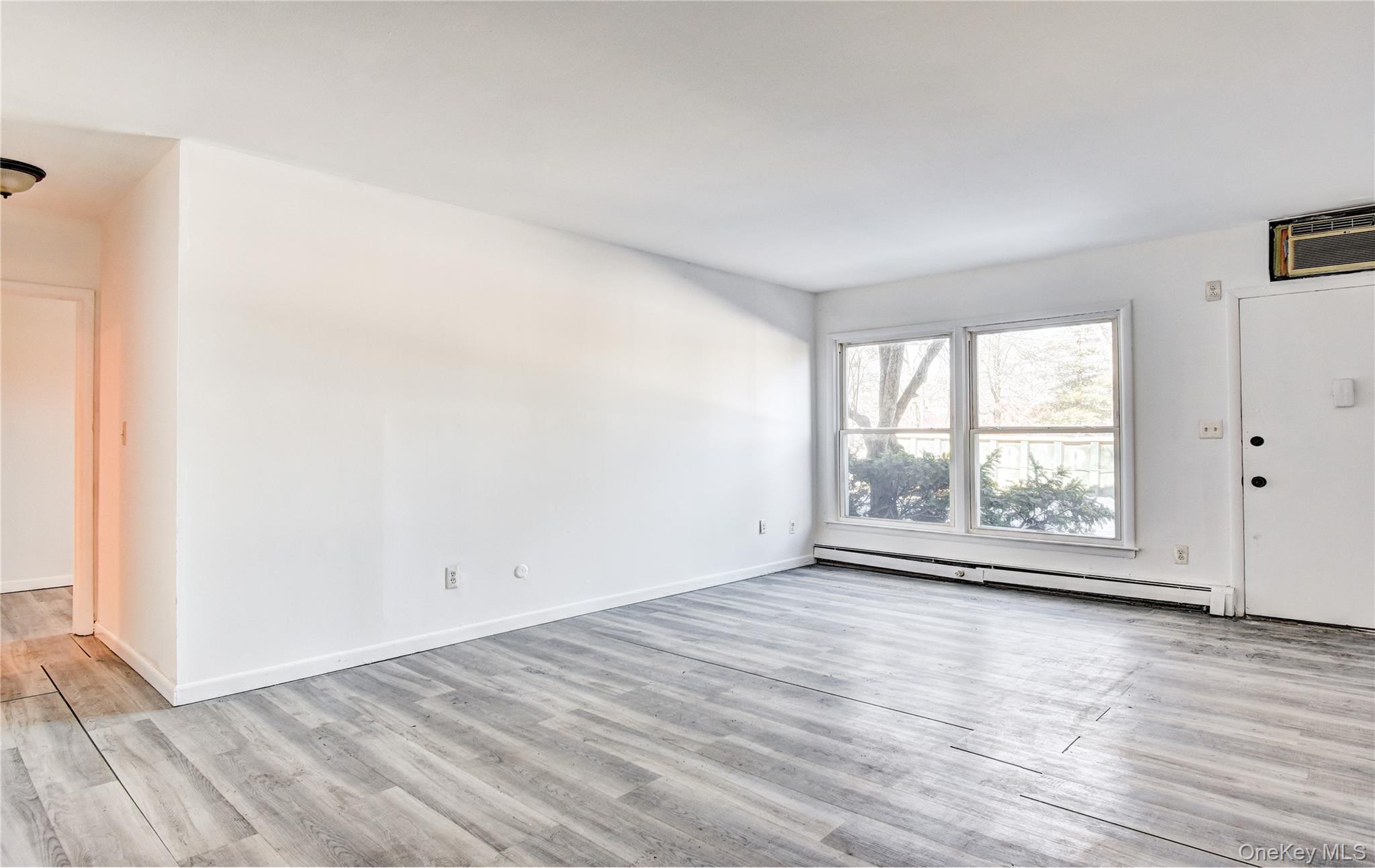 19 Gerald Drive, Unit B2 Poughkeepsie, NY 12601 - Photo 7 of 14 an empty room with wooden floor and windows