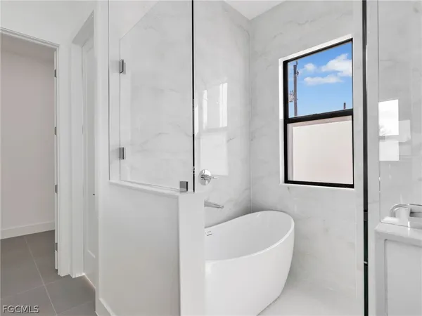 a bathroom with a bathtub and shower