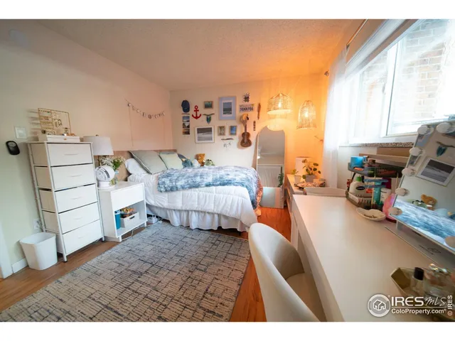 a bedroom with furniture and a large window
