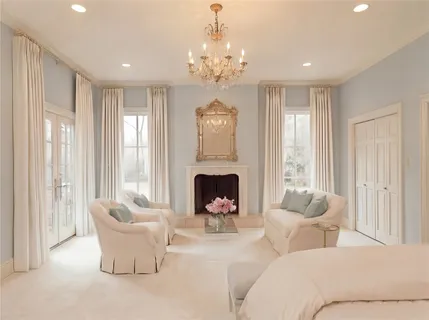 a view of a livingroom with a fireplace and windows
