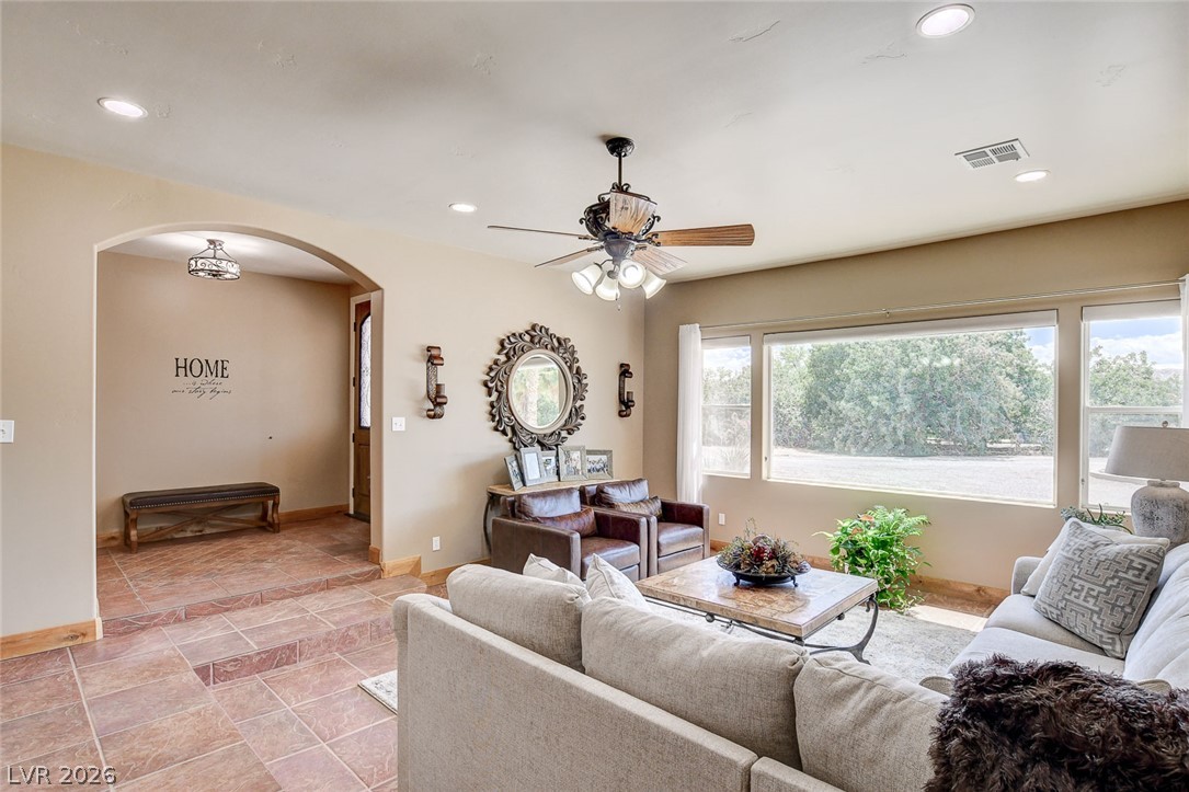 1950 Bowman Road Logandale, NV 89021 - Photo 7 of 81 Step into a sun-filled living space offering ample natural light and a gracious arched entryway.