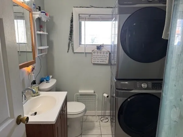 a bathroom with a sink toilet and mirror