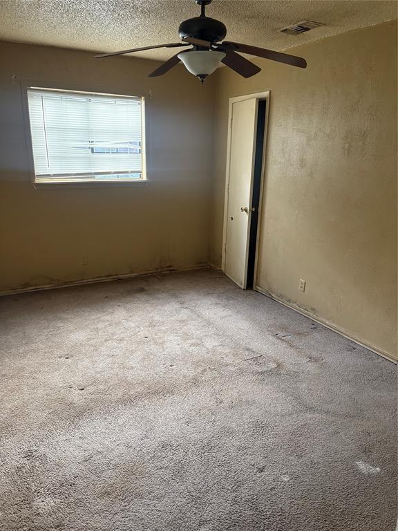 609 Bethlehem Street Terrell, TX 75160 - Photo 13 of 19 an empty room with a ceiling fan and a window