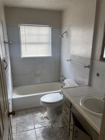 a bathroom with a sink a toilet and a bathtub