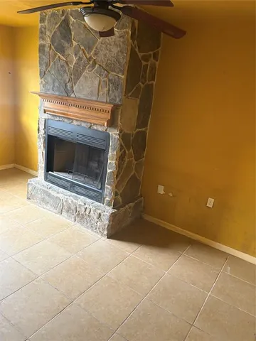 a view of empty room with a fireplace