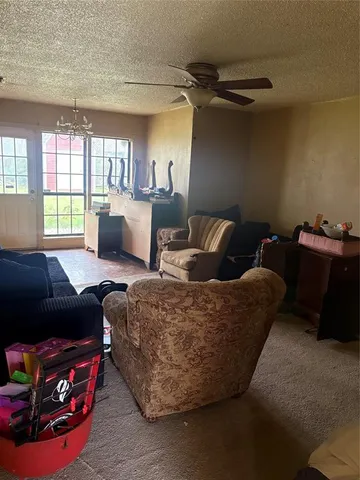 a living room with furniture a flat screen tv and a window