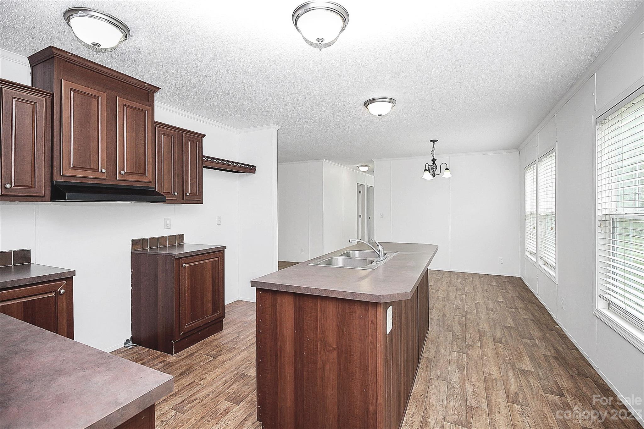 812 Margrace Road Kings Mountain, NC 28086 - Photo 20 of 34 a kitchen with granite countertop sink cabinets and wooden floor