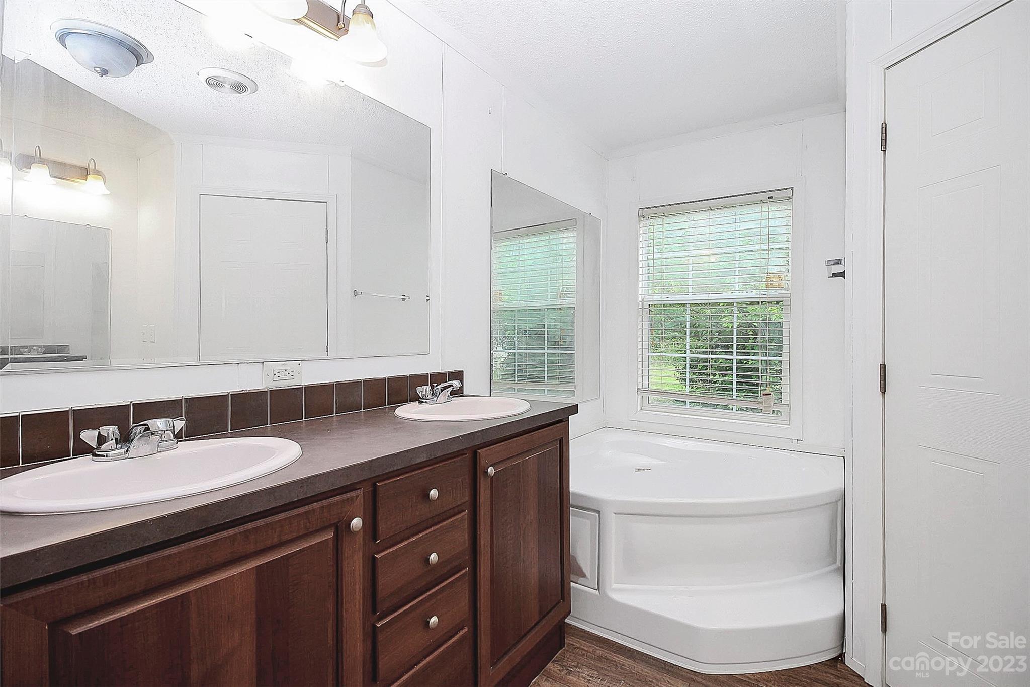 812 Margrace Road Kings Mountain, NC 28086 - Photo 28 of 34 a bathroom with a granite countertop sink a toilet a mirror and a tub