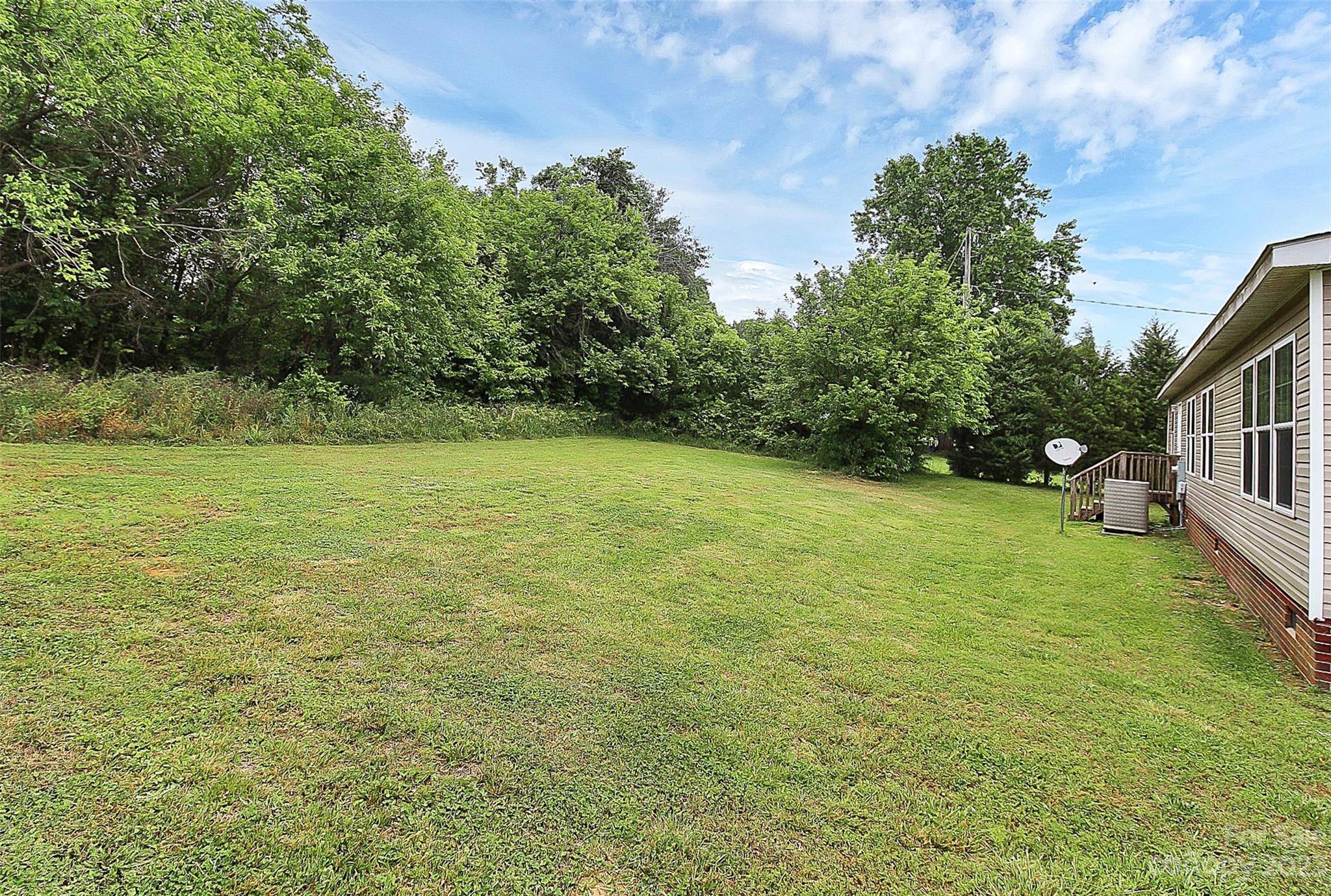 812 Margrace Road Kings Mountain, NC 28086 - Photo 9 of 34 a view of a big yard with plants and large trees