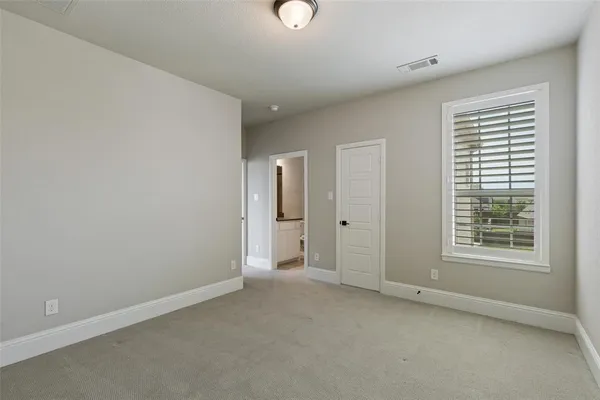 an empty room with windows and closet