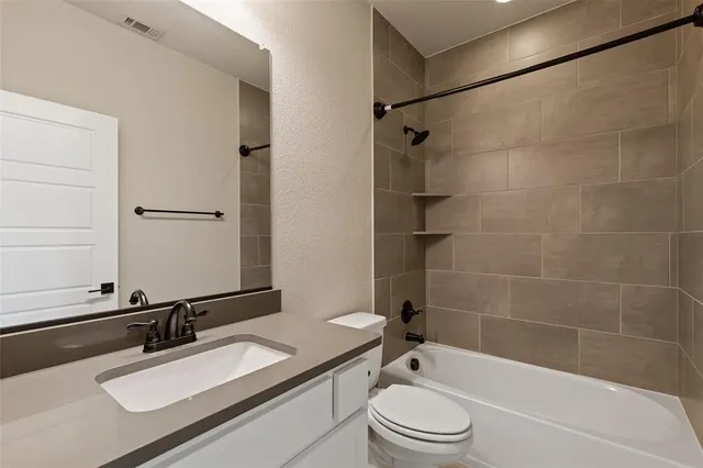 a bathroom with a sink a toilet and a bathtub