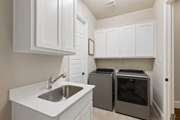 a kitchen with white cabinets and a sink