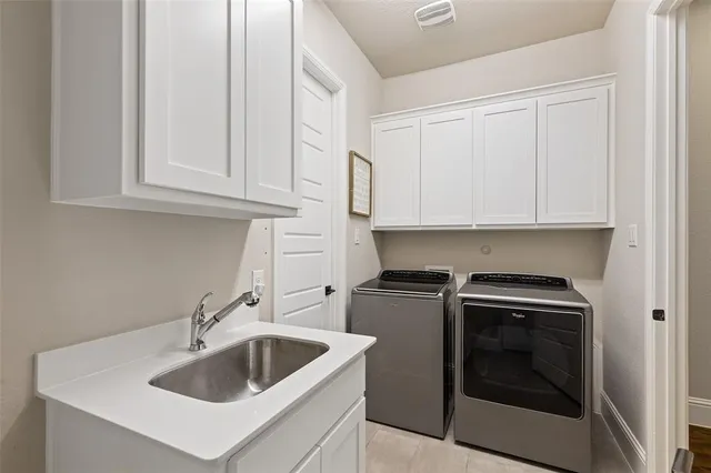 a kitchen with white cabinets and a sink