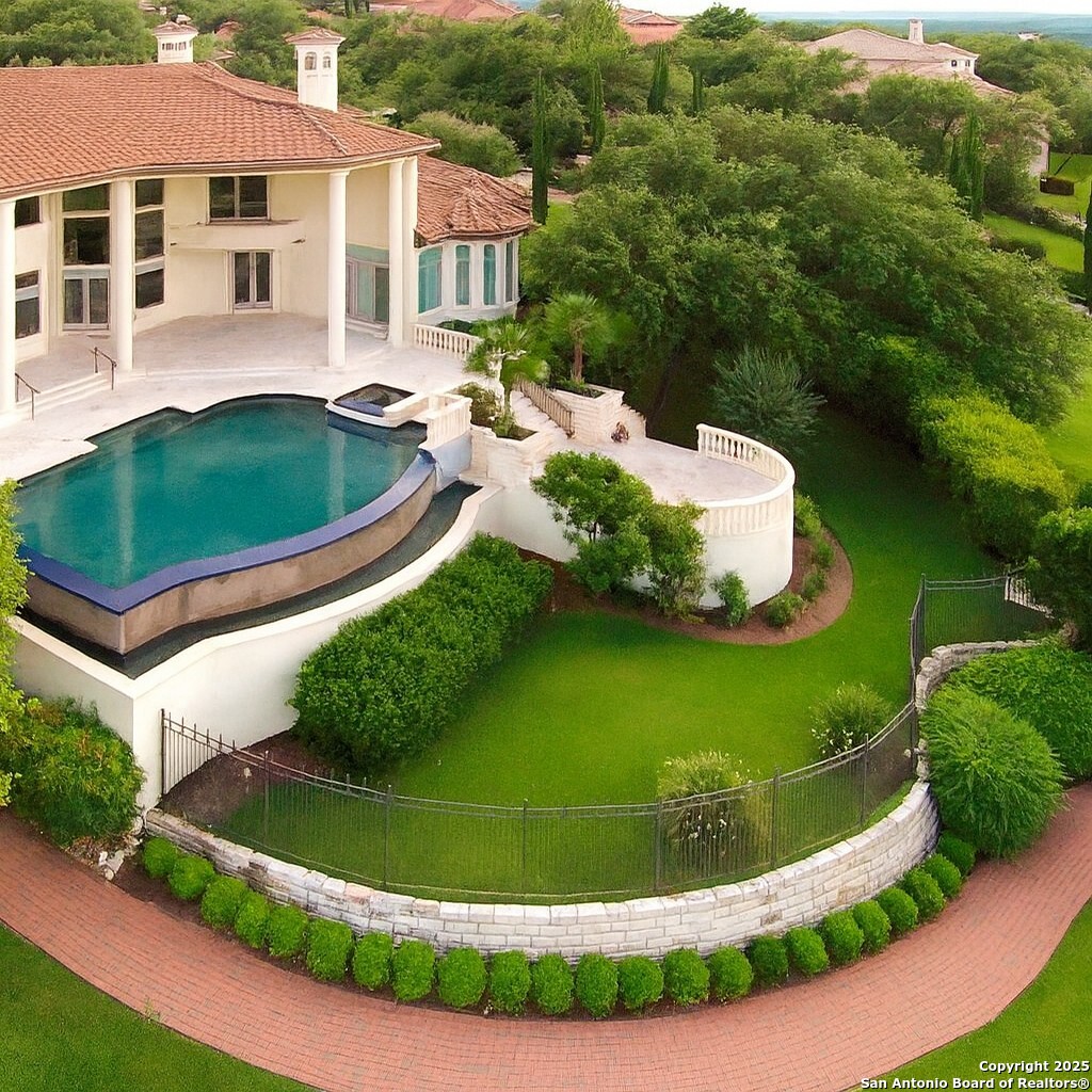 217 Bella Riva Drive Austin, TX 78734 - Photo 1 of 38 a view of a swimming pool in he middle of the green field
