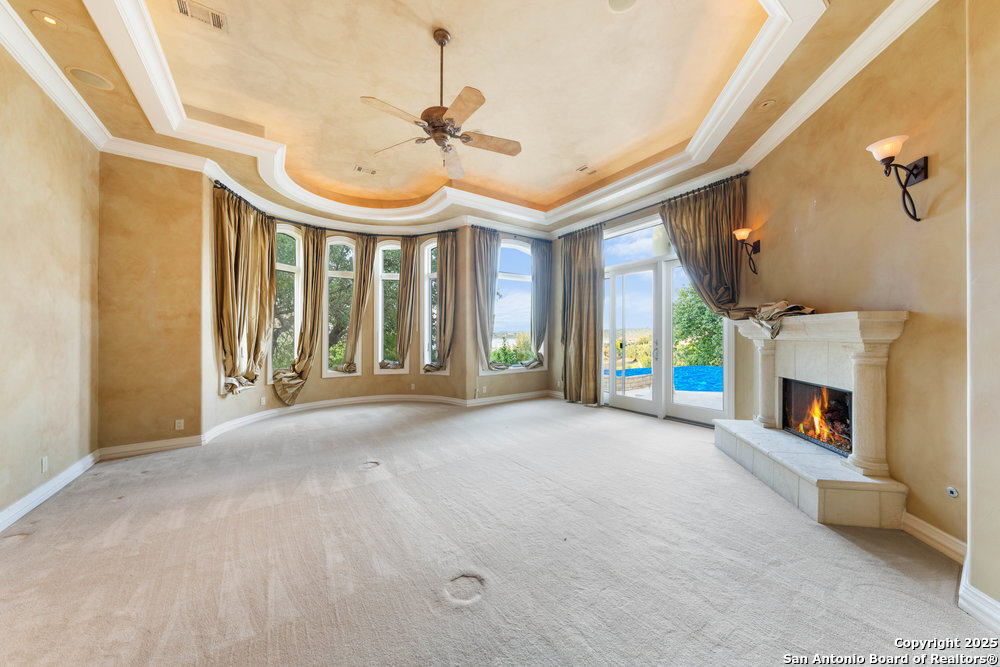 217 Bella Riva Drive Austin, TX 78734 - Photo 20 of 38 a view of an empty room with a fireplace and a window