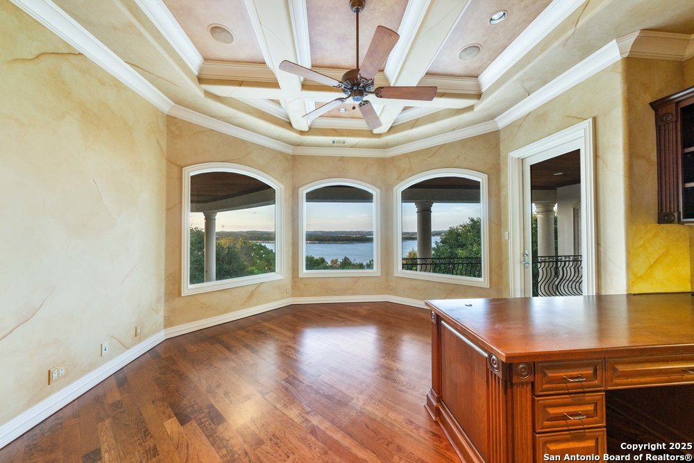 217 Bella Riva Drive Austin, TX 78734 - Photo 25 of 38 a view of a hall with wooden floor and a large window