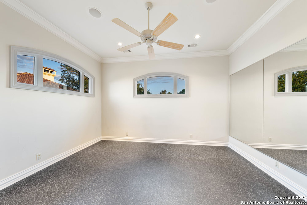 217 Bella Riva Drive Austin, TX 78734 - Photo 26 of 38 an empty room with a ceiling fan and window
