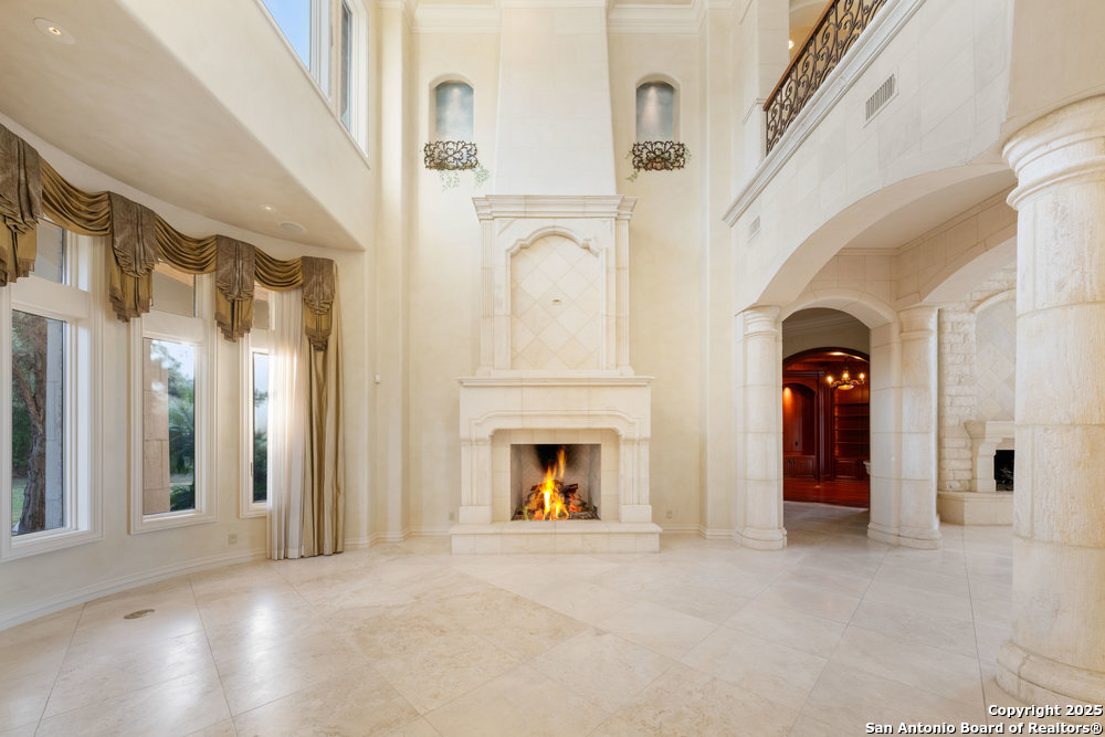 217 Bella Riva Drive Austin, TX 78734 - Photo 5 of 38 a view of a livingroom with a fireplace wooden floor and windows
