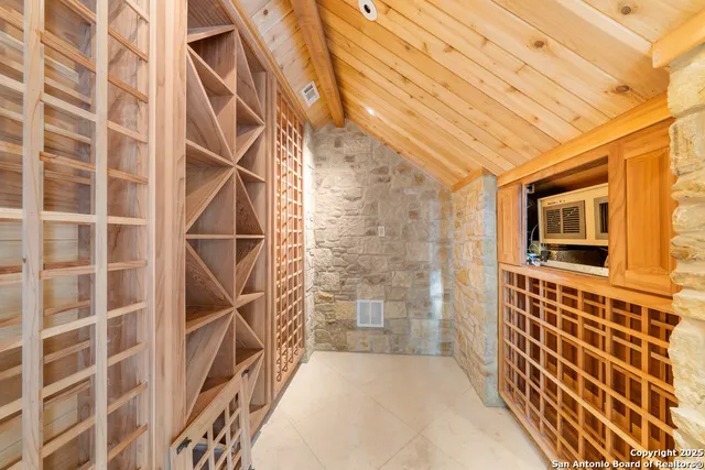 an empty room with a fireplace and windows