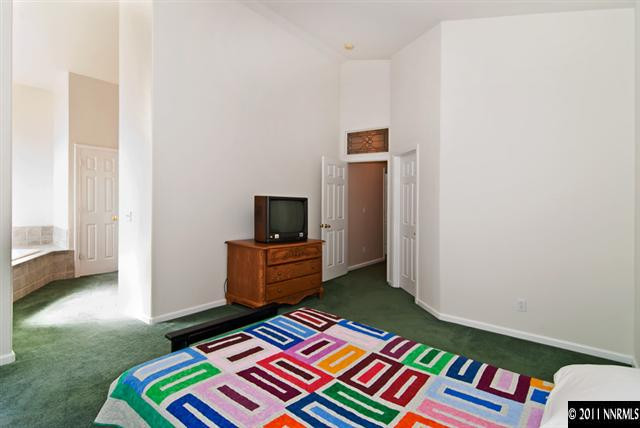 1462 Amston Road Reno, NV 89511 - Photo 10 of 13 a bedroom with a bed and a television