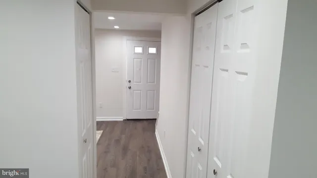 a view of a hallway with wooden floor
