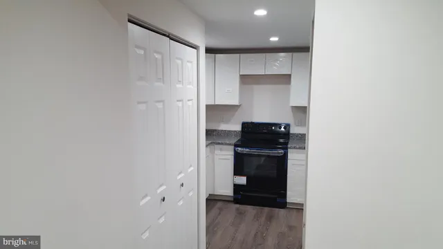a kitchen with a refrigerator and a stove top oven