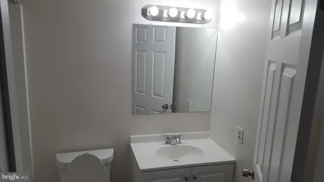 a bathroom with a sink a mirror and vanity